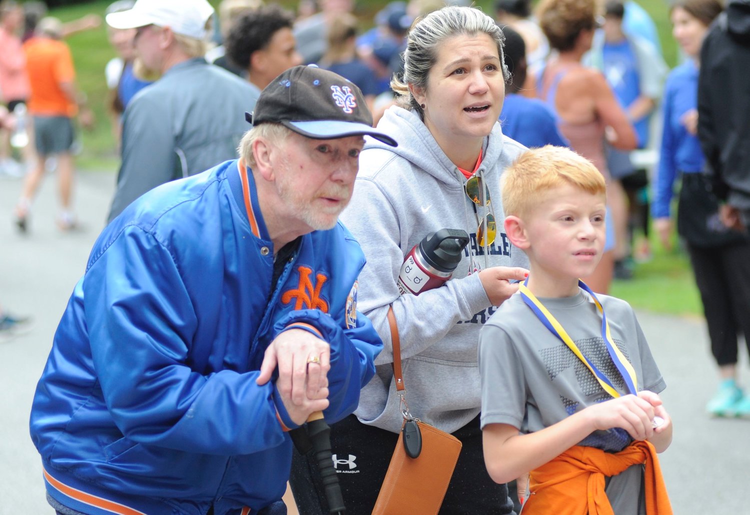 At the finish line. Nine-year-old Bradley Kenney, a third-grader at  Tri-Valley,  took first place in the male 10 and under category, and completed the race 69th overall with a time of 24:10. He is pictured with Edward Kenney, left, the young runner’s grandfather; and his mom Michelle.